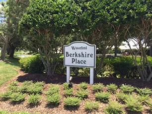 Mown lawns and mature planting outside homes at Berkshire Place