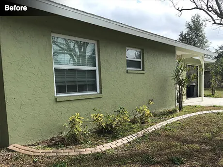The front of the house before the cleanup, with tired and patchy planting