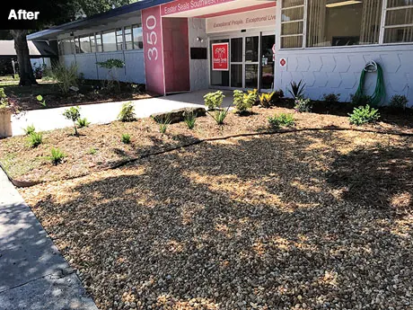 The replanted entrance with new beds, mulch and river rock